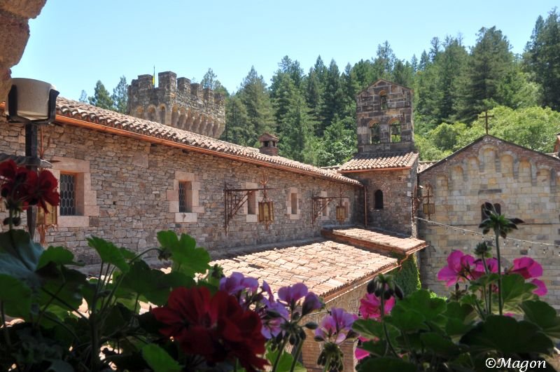Castello Di Amorosa: каменные стены, черепица и цветы в тени леса